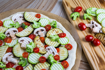 Homemade pizza with vegetables, natural dough on leaven. With zucchini, eggplant, cherry tomato, broccoli, mushrooms. The concept of a healthy diet. Vegetarian.