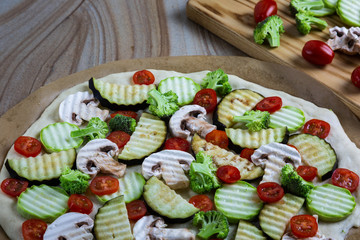 Homemade pizza with vegetables, natural dough on leaven. With zucchini, eggplant, cherry tomato, broccoli, mushrooms. The concept of a healthy diet. Vegetarian.