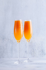 two glasses of fruit champagne on the table. refreshing festive cocktail