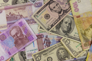 Fototapeta na wymiar Multicurrency background of the us dollars, russian rubles and ukrainian hryvnias