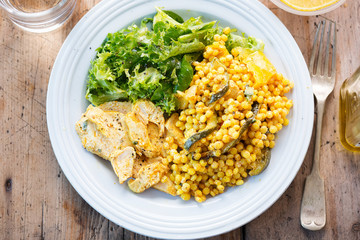 Fiery Moroccan chicken with giant spicy couscous, roasted vegetables and tzatzaki dressing 