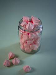 Colorful meringues in a transparent jar