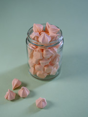 Colorful meringues in a transparent jar