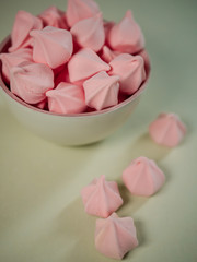 Colorful meringues in a mint green bowl