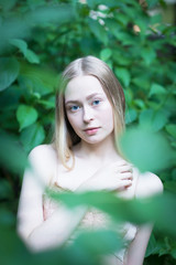 Portrait of young blonde girl in the garden