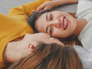 Fototapeta premium Young asian woman lesbian couple smiling happiness on the bed at home. Concept lesbian lifestyle.