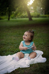 Little girl sitting in the grass.