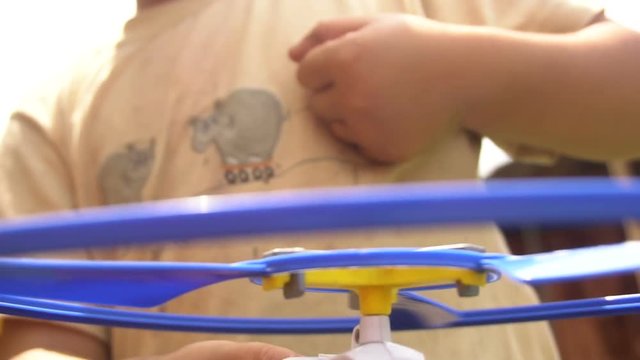 Little Boy Playing With A Toy Helicopter Slow Motion