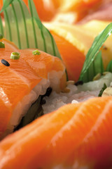 A set of sushi and rolls with salmon. Macro. Background..  Vertical shot.
