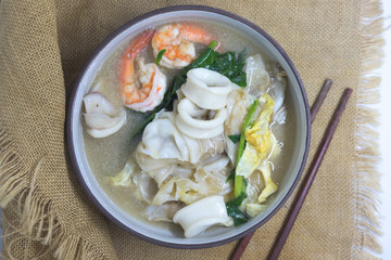 Fried noodle with seafood and kale soaked in gravy