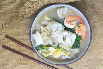 Noodle in creamy gravy sauce with shrimp and squid