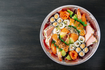 A set of sushi in a metal container on a black background. Top Vieux..Copyspace.