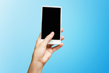 Mockup of female hand holding frameless cell phone with black screen isolated at blue background.