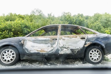 destroyed car by the road. burned car. car crash