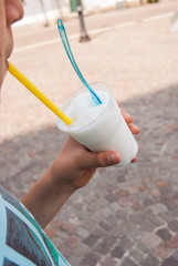 Child eating strawberry and pink sicilian granita