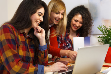 Group of female students study at home, learning for university exam.	