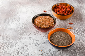 Obraz na płótnie Canvas Chia seeds, flax seeds and goji berries