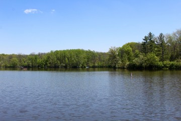 A beautiful day on the lake in the park in the spring season.