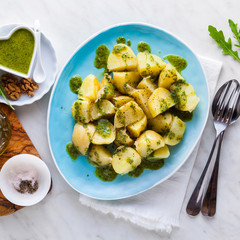young potatoes, steamed, with pesto of arugula and nuts. tasty healthy summer food.