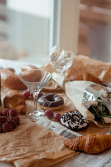 Fototapeta na wymiar Still life, food and drink concept. Breakfast with croissants, fruits and champagne. Selective focus