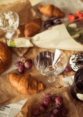 Still life, food and drink concept. Breakfast with croissants, fruits and champagne. Selective focus, top view flat lay
