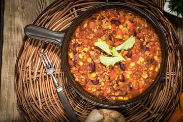 Chili con carne in a clay pan.