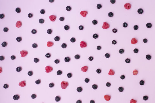 .Summer background of many different berries of black and pink.