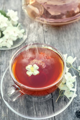 Hot tea with Jasmine in a glass transparent Cup.