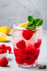 Cold drink Raspberry Lemonade with mint in glass.