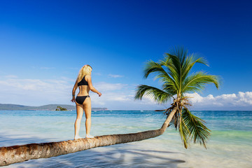 girl making steps on the palm tree