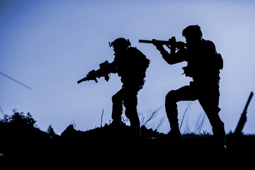 Fototapeta na wymiar Black silhouettes of pair of soldiers