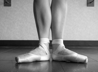 Black and white version of Ballerina in Ballet first position in ballet pointe shoes and bare legs  © Katherine BYC