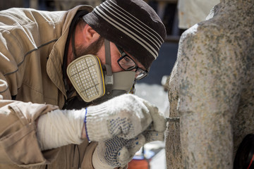 Restorer is engaged in the restoration of the statue