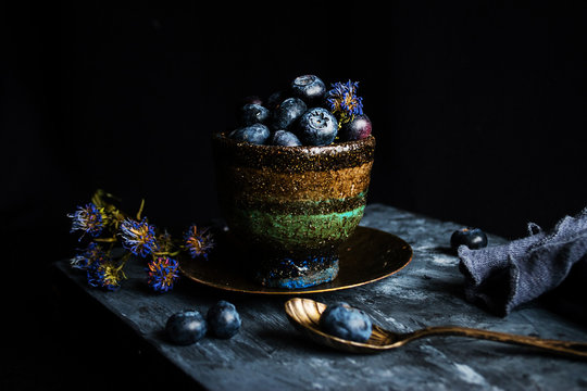 Handmade cup with blueberries.