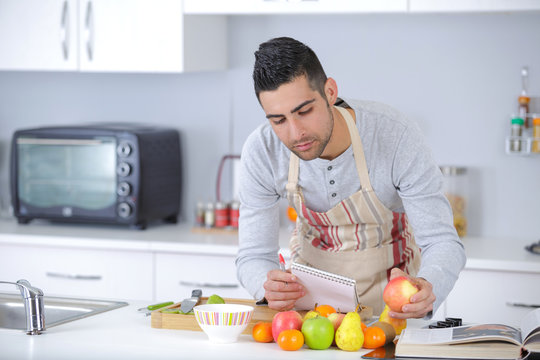 chef in apron preparing delicious fruit based recipe