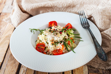 Cooked rice with vegetables, cod and lemon sauce