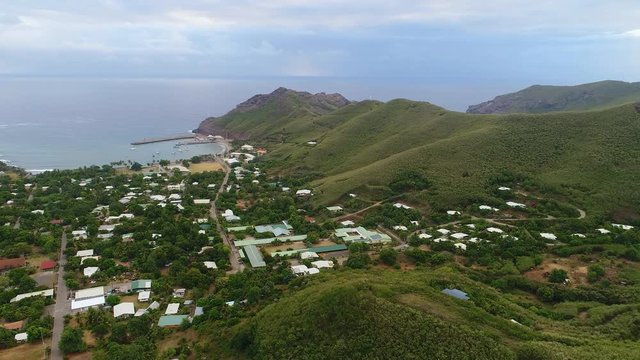 Aerial panoramic view of Hakahau town on Ua Pou island - South Pacific Ocean, Marquesas Islands, landscape panorama of French Polynesia from above, 4k