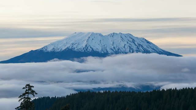 Ultra high definition time lapse video of white moving clouds over snow covered Mt St Helens in Washington state 4k UHD