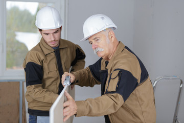carpenter teaching his trainee
