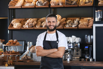 Male baker standing in shop - Powered by Adobe