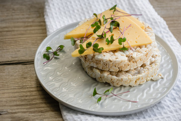 Crisp bread with cheese and micro-greens. .