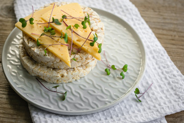  Crisp bread with cheese and micro-greens. 
