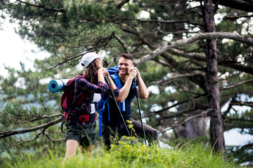 Happy couple hiking outdoors in forest