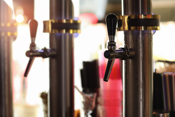 Draft beer taps in modern bar