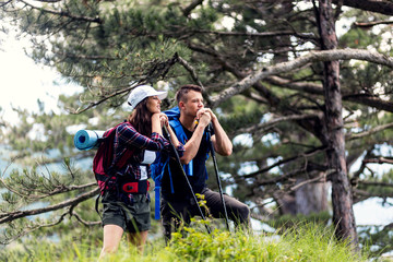 Fototapeta na wymiar Happy couple hiking outdoors in forest