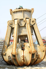 brown industrial claw, used to unload rocks, coal and other minerals in the mining industry