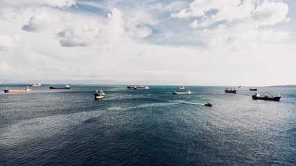 Obraz premium Aerial Sinematic Drone View of Cargo Ships in the Ocean Sea Coming Towards to Camera.