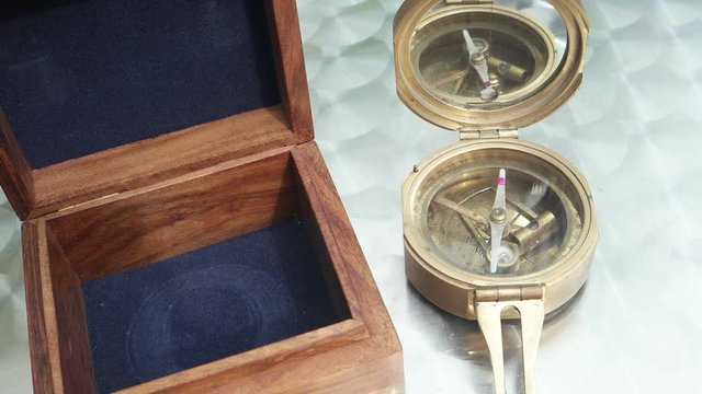 Vintage sea compass with wooden case on the table