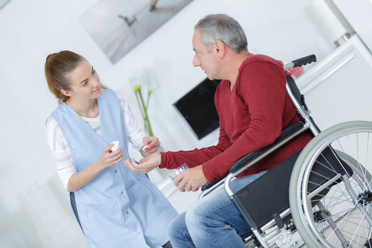 elderly man on wheelchair and his nurse