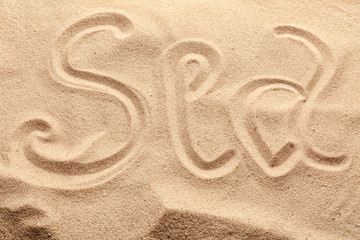 Fototapeta na wymiar Word SEA written on beach sand